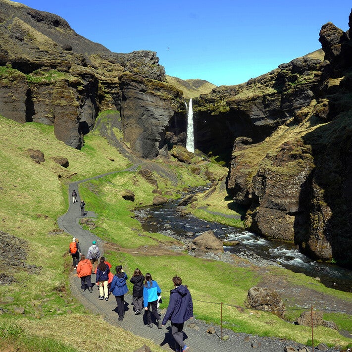 penn students hiking near a waterfall
