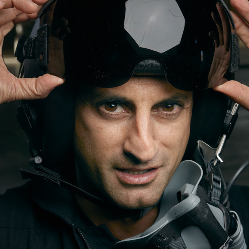 Jameel Janjua, a spaceline pilot and astronaut with Virgin Galactic, wearing a helmet and mask while looking into the camera.